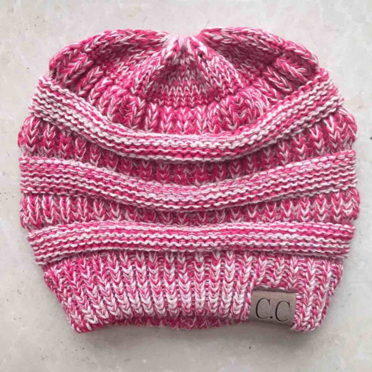 Magenta knit ponytail beanie with striped band and CC logo patch on front