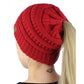 Chunky knit ponytail cap beanie in red with back opening for pulling hair through.