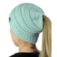 Cable-knit ponytail cap beanie in light aqua with back opening for ponytail hair.