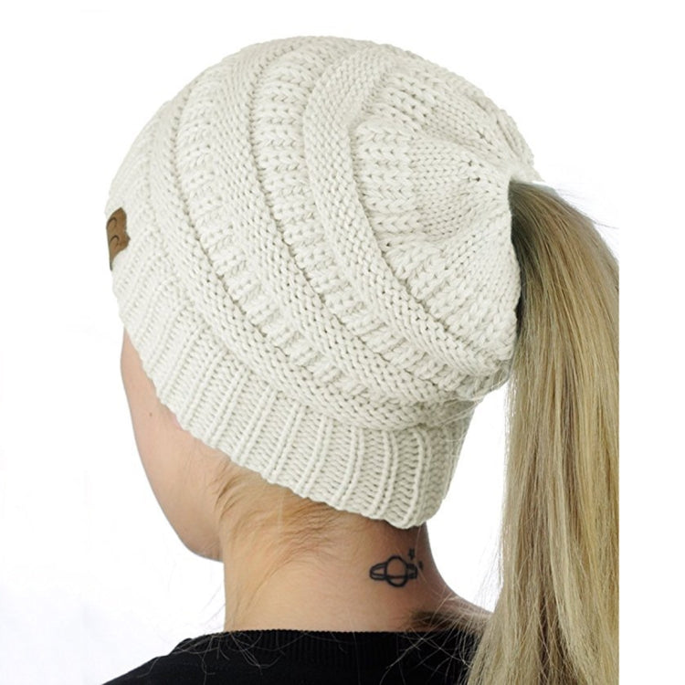 White knitted ponytail cap beanie with ribbed knit texture and folded cuff