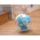 Clear hollow plastic ball ornament with blue rose and floral filler inside