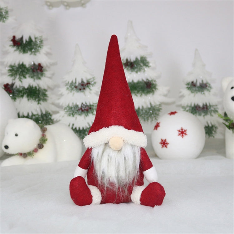 Red felt gnome window ornament with white fur trim, beige nose, and long white beard