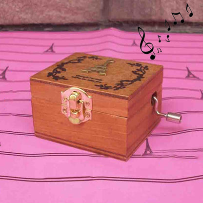 Wooden music box with engraved lid, pink lock, and side winding crank