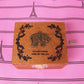 Wooden music box with ornate laurel engraving and elephant motif on the lid