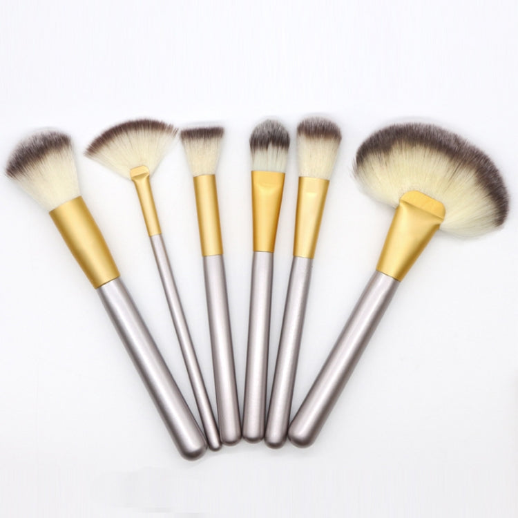 Set of silver-handled makeup brushes with gold ferrules and fluffy brush tips