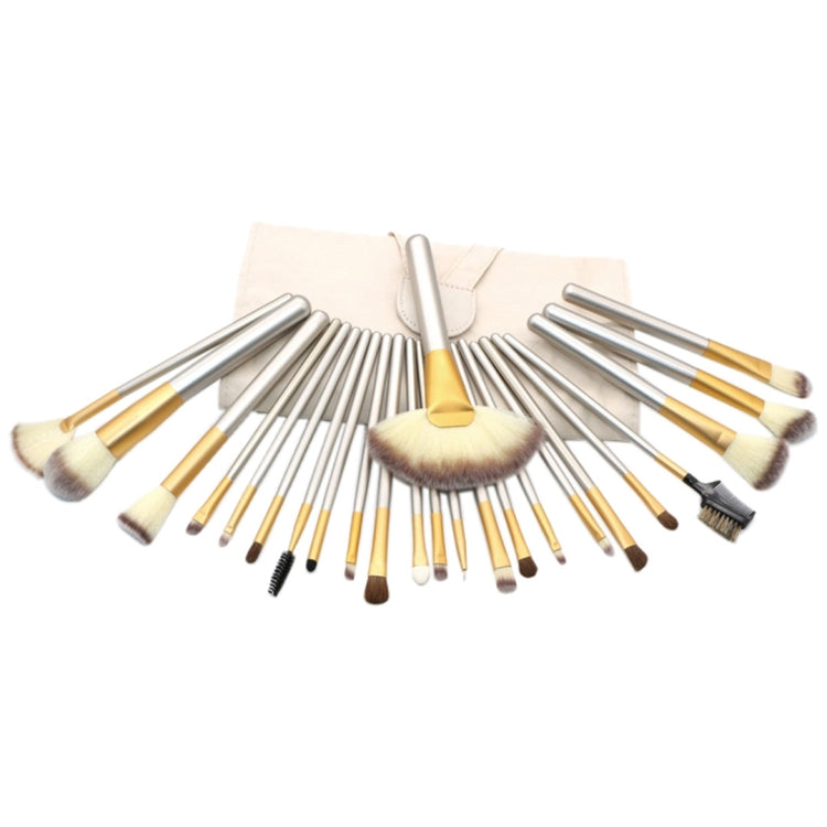 Makeup brush set fanned out: powder brush and small detail brushes in beige pouch