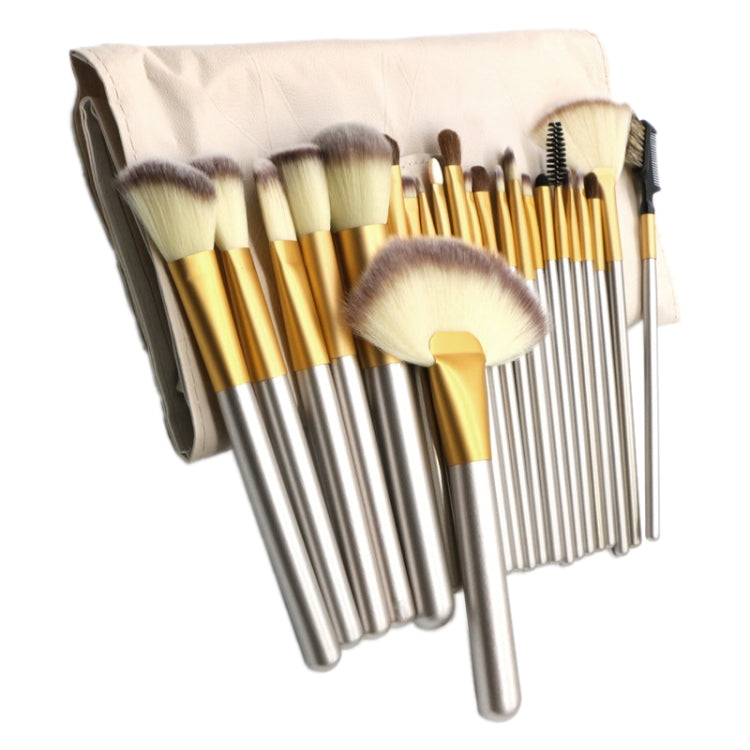 Makeup brush set in beige roll pouch, silver handles with gold ferrules and brush heads