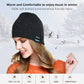 Black knit beanie with Bluetooth control panel patch, worn on a woman’s head.