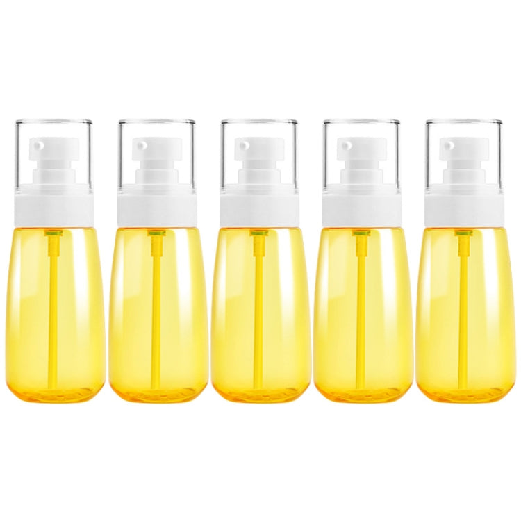 Five 60ml yellow translucent plastic travel bottles with white pump sprayers