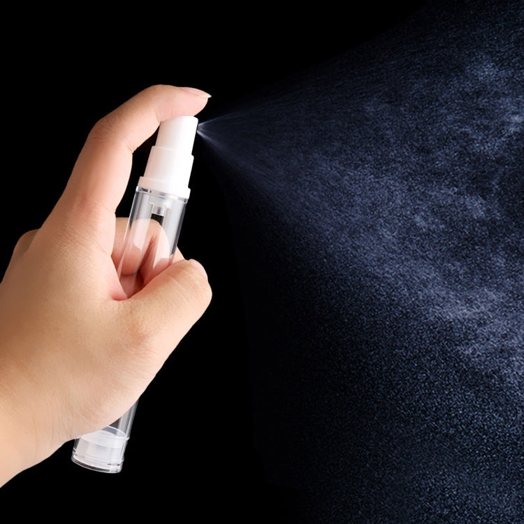 Hand holding a clear airless spray bottle with white fine-mist pump