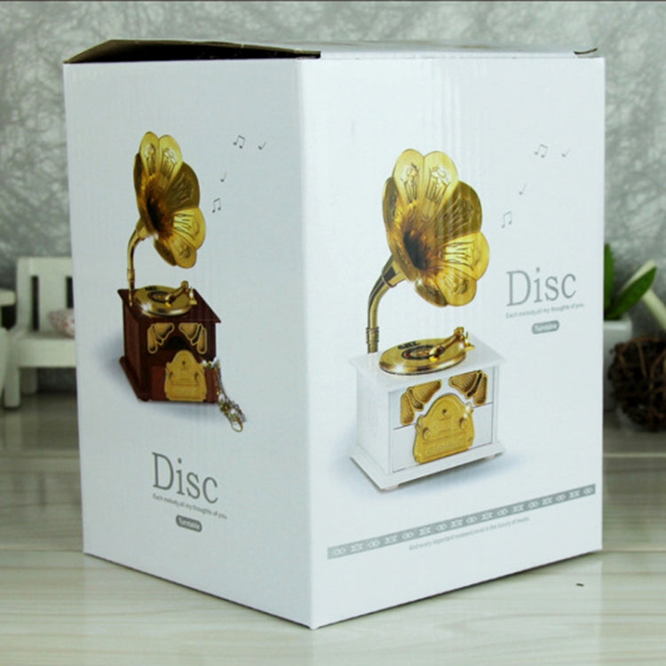 Phonograph-style music box retail packaging showing gold-tone unit with horn