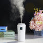 White humidifier cylinder with LED panel and rising mist