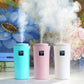 Set of three humidifiers in blue, pink, and white with LED panels and mist