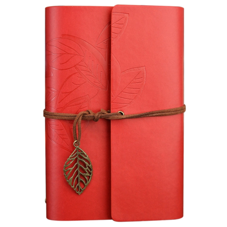 Red leather-look travel diary notebook with embossed leaves, wrap strap, and hanging leaf charm