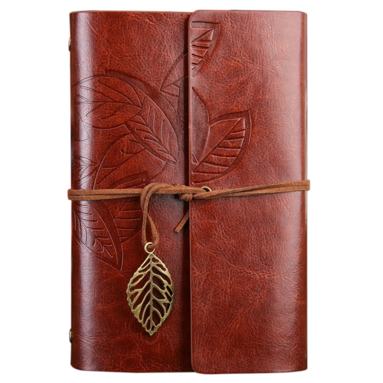 Brown leather-look travel diary notebook with leaf embossed cover, wrap strap, and gold leaf charm