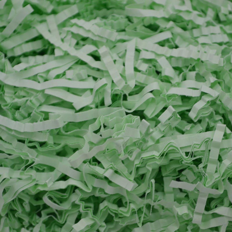 Light green shredded paper filler strips, crumpled and crinkle-textured