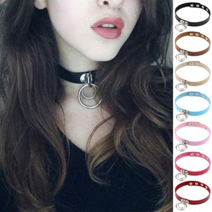 Black leather punk choker necklace with silver dual rings on a model’s neck