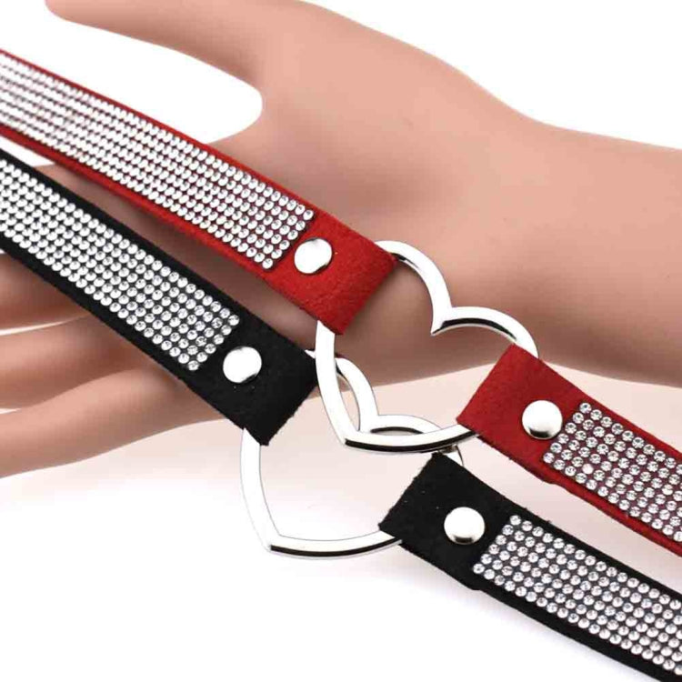Rhinestone heart choker necklace on wrist with red, black, and silver heart hardware