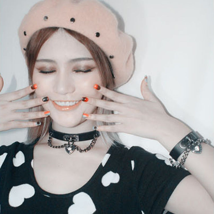 Heart-lock leather choker with chain links and heart charm, plus matching wrist band