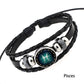 Black braided leather zodiac bracelet with round blue-green charm and silver clasps