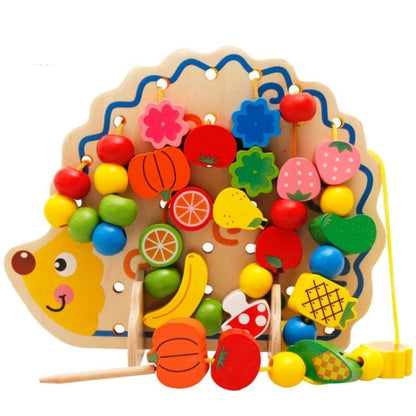 Wooden hedgehog bead board toy with colorful fruit-shaped pieces and lacing strings