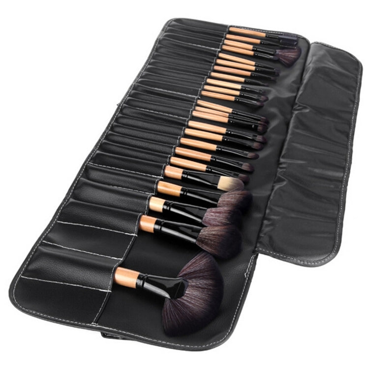 Open PU leather brush roll showing black pockets and 32 brushes with wood-tone handles