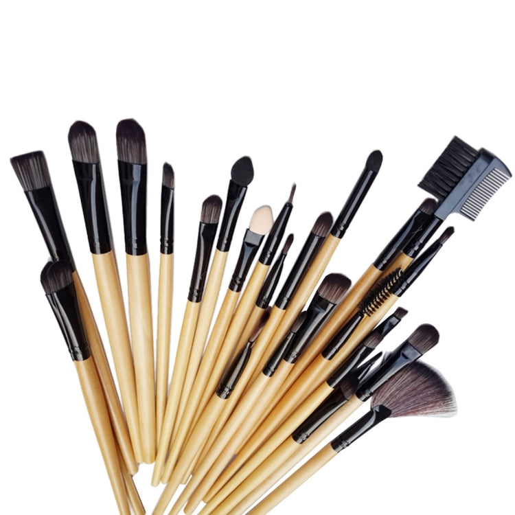 Assorted makeup brushes with light wood handles and dark bristles in a neat lineup
