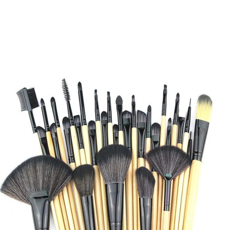 Assorted makeup brushes with light wood handles, black ferrules, and varied brush shapes