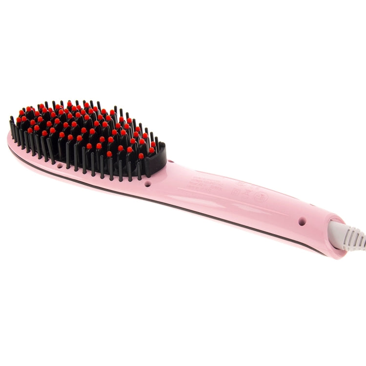 Pink heated hair straightener comb lying flat with red-tipped comb pins