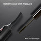 Black heated eyelash curler beside mascara brush with bristle wand