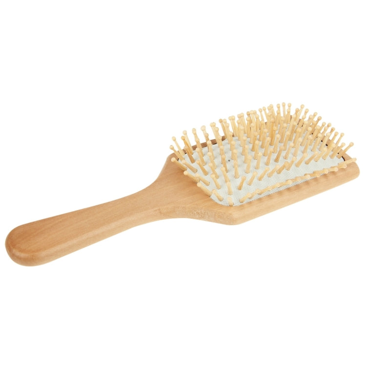 Large wooden hair brush with white rubber base and dense rounded pins