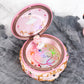 Open pink rotating music box with ballerina figure and colorful light-up carousel
