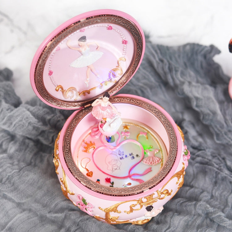 Open pink rotating music box with ballerina figure and colorful light-up carousel