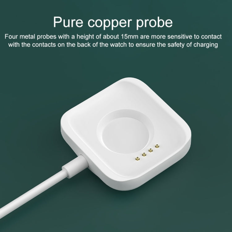 White magnetic watch charging base with circular contact area and gold contact pins