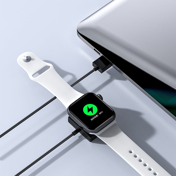 Magnetic wireless charger attached to a white smartwatch band with green status light