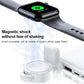 Black magnetic wireless charger on strap with Apple Watch resting on white base dock