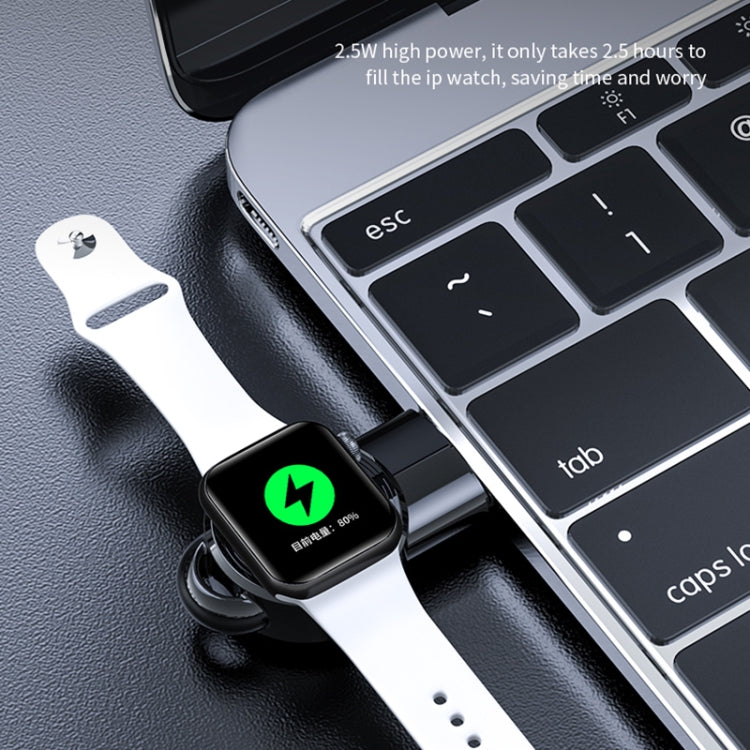 Black magnetic wireless watch charger connected to laptop USB port