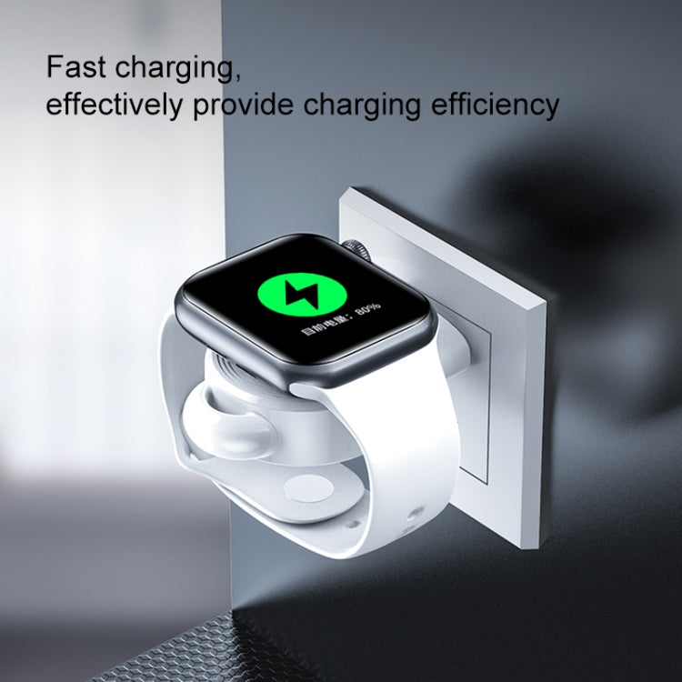 Black magnetic wireless watch charger docked on a wall adapter