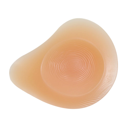 Left silicone breast pad back side with circular spiral texture, peach tone.