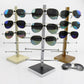 Wood sunglasses display rack with multiple metal arms on bases, holding many pairs of shades