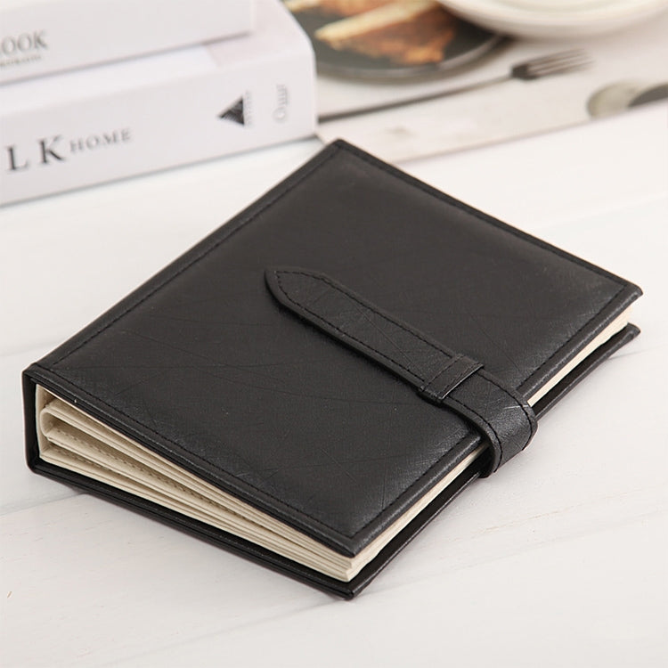Black book-shaped earring display rack with strap and stacked inner pages