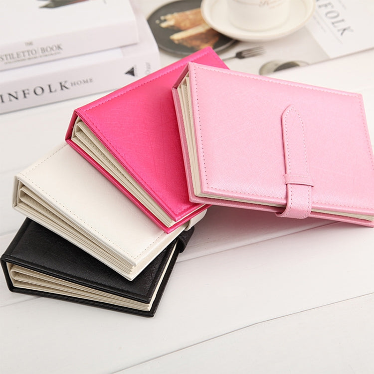 Pink and light cream book-shaped earring display rack with buckle strap