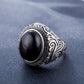 Men’s oval black-stone ring with engraved silver swirl border and filigree band
