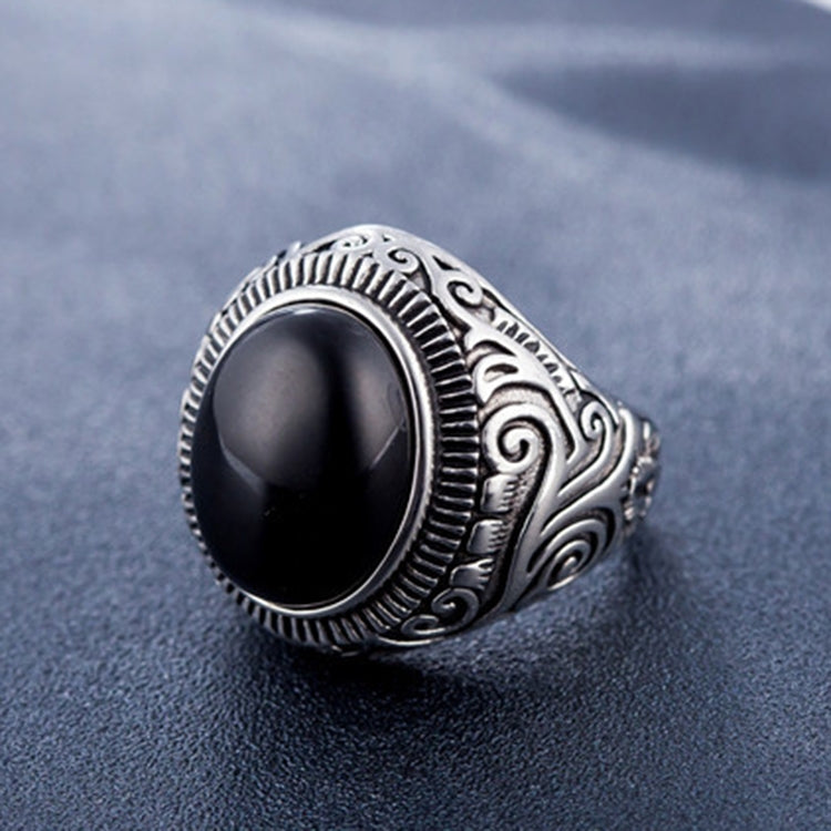 Men’s oval black-stone ring with engraved silver swirl border and filigree band