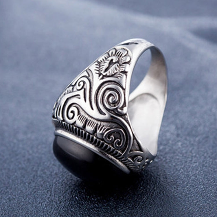 Men's titanium steel ring side view with black oval stone and decorative metalwork
