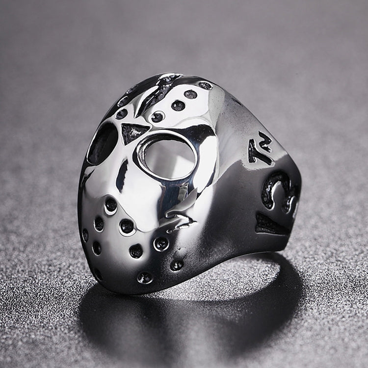 Angle view skull mask ring with flame-like emblem, open eye cutout, studs