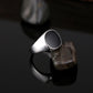 Silver-tone ring with black oval top, dramatic side angle
