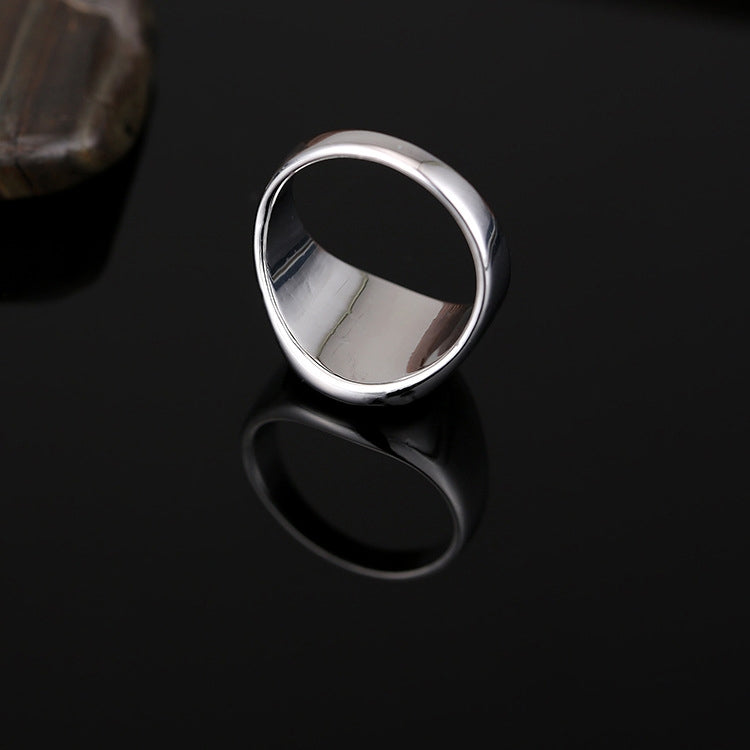 Silver-tone drip signet ring with black oval face, top view