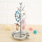 Silver-toned tree jewelry display with bird charms and pearl, blue, and pink beads