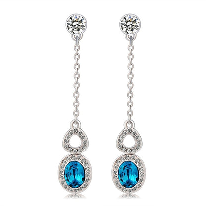 Silver-plated blue crystal drop earrings with clear stone accents and linked chains